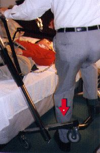 photo of man balancing lift with foot while trying to get person off the bed